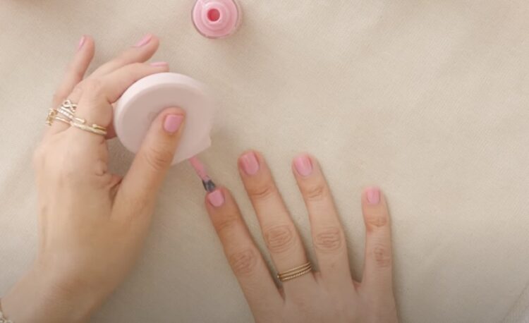 Woman's hands applying nail polish